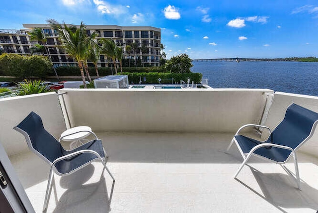 balcony featuring a water view