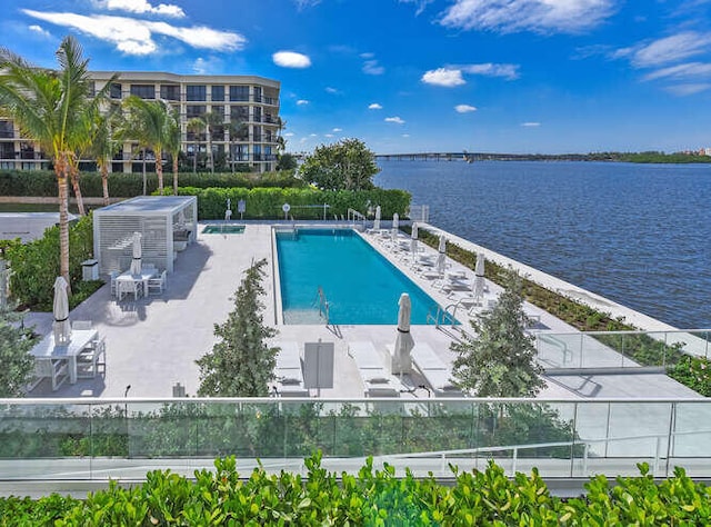 view of pool featuring a patio area and a water view