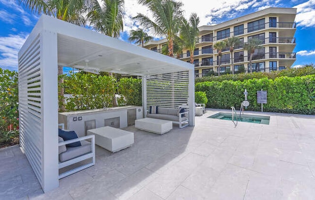 view of patio with outdoor lounge area and a pool