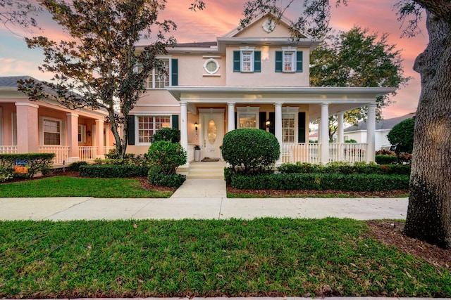 view of front of house featuring a porch and a yard