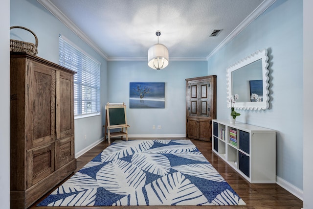 bedroom featuring dark wood-type flooring, a textured ceiling, and ornamental molding