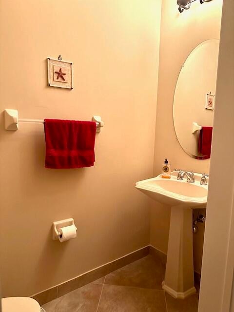 bathroom featuring toilet and tile patterned floors