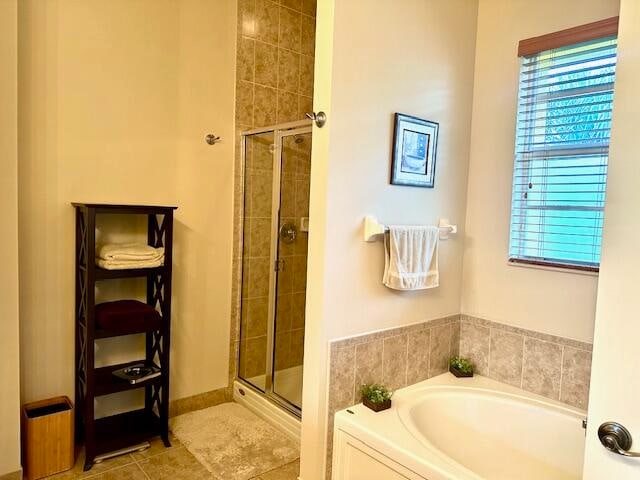 bathroom with tile patterned flooring and plus walk in shower