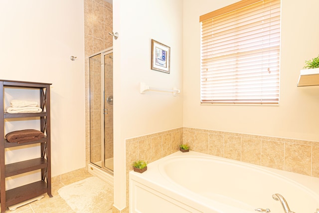 bathroom featuring tile patterned floors and shower with separate bathtub