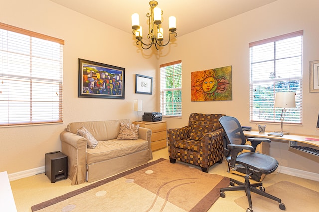 home office with carpet floors, a wealth of natural light, and a chandelier