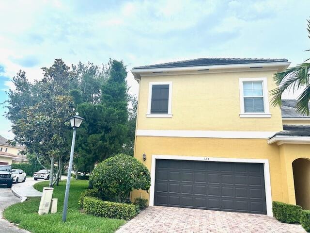 view of home's exterior with a garage and a yard