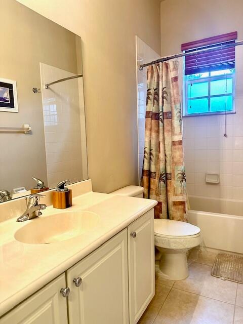 full bathroom with tile patterned floors, vanity, toilet, and shower / bath combo with shower curtain