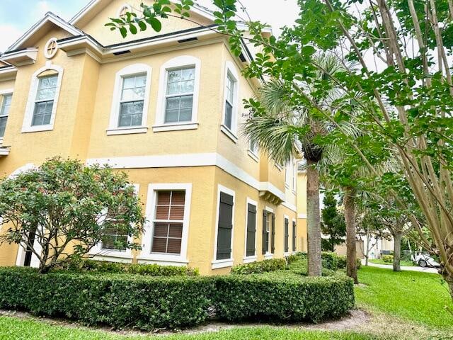 view of side of home with a lawn