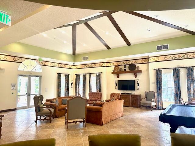 living room with french doors, lofted ceiling, and billiards