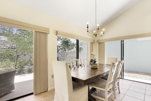 dining area featuring light tile patterned floors, vaulted ceiling, and an inviting chandelier