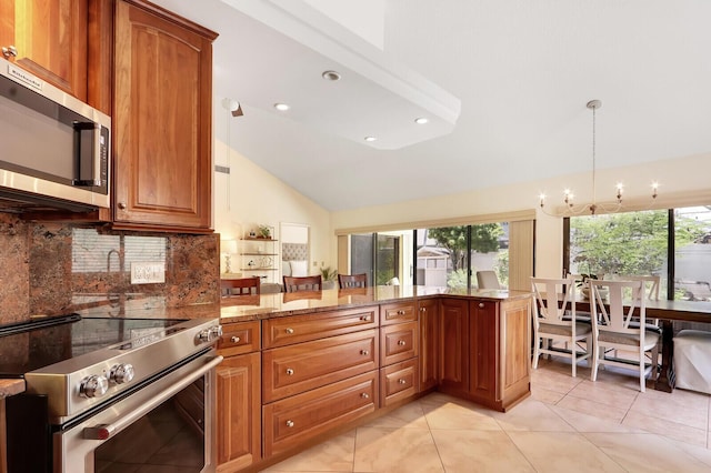 kitchen with kitchen peninsula, stainless steel appliances, hanging light fixtures, and a healthy amount of sunlight