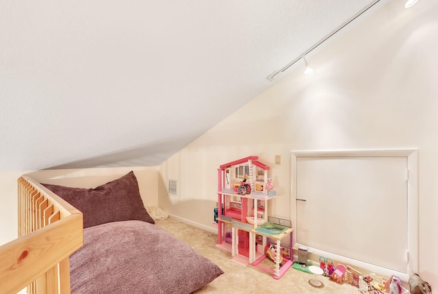 playroom featuring light colored carpet and track lighting