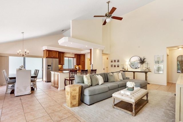 living room featuring ceiling fan with notable chandelier, high vaulted ceiling, and light tile patterned flooring