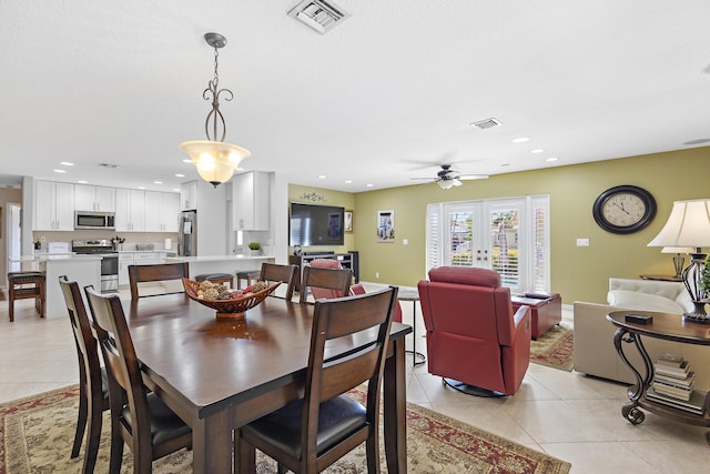 tiled dining area featuring french doors and ceiling fan