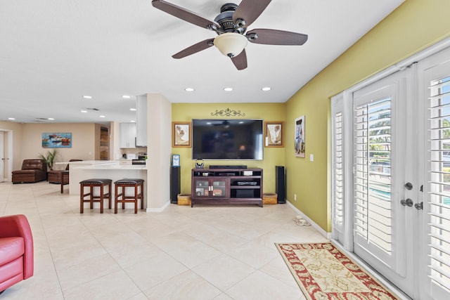 living room featuring light tile patterned flooring and ceiling fan