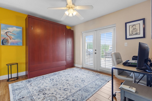 home office featuring ceiling fan, french doors, and light hardwood / wood-style flooring