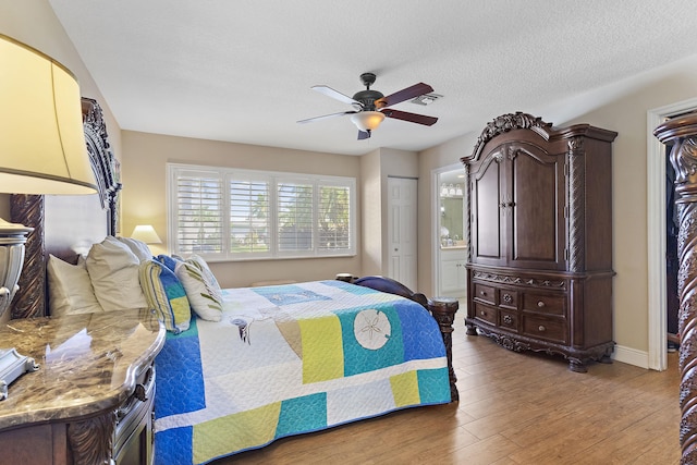 bedroom featuring ceiling fan, a textured ceiling, a closet, and hardwood / wood-style floors