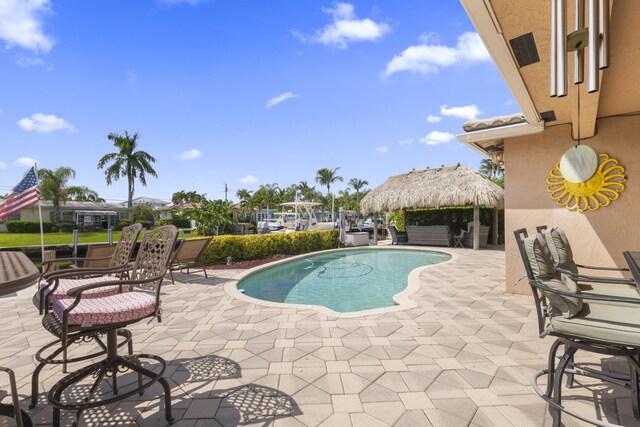 view of swimming pool featuring a patio and a gazebo