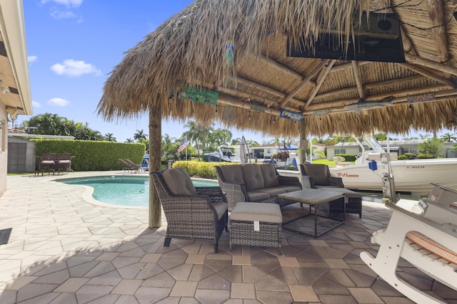 view of patio / terrace with an outdoor hangout area, a gazebo, and a fenced in pool