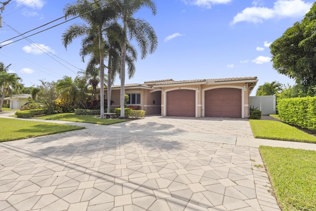 mediterranean / spanish home with a garage and a front yard