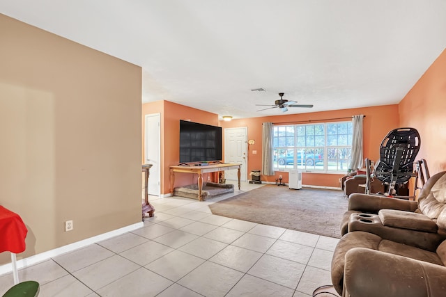 living room featuring light tile patterned floors and ceiling fan