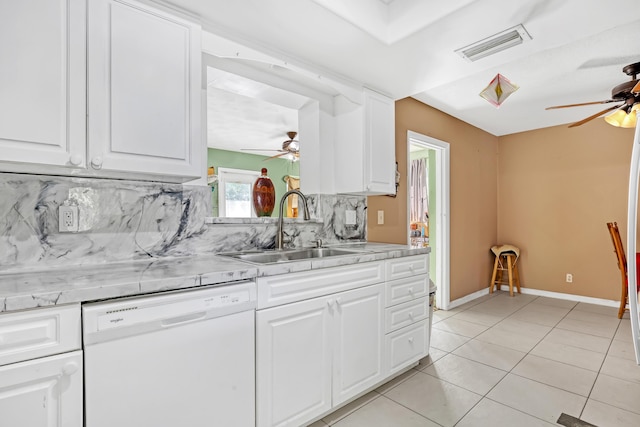 kitchen with white cabinetry, white dishwasher, sink, and light tile patterned floors