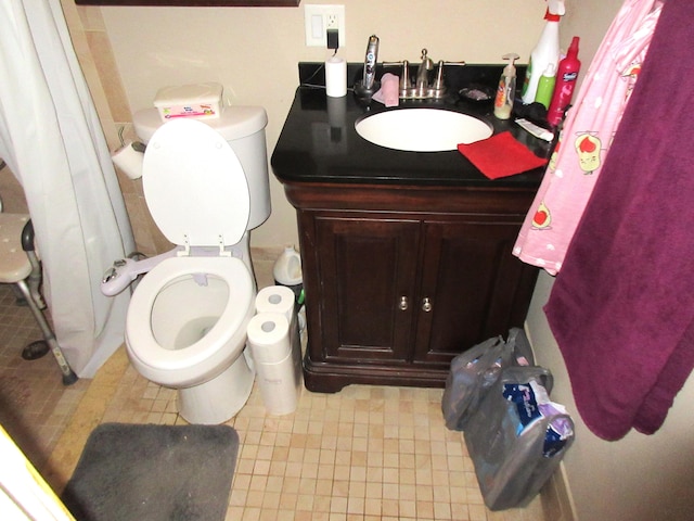 bathroom with tile patterned floors, vanity, and toilet