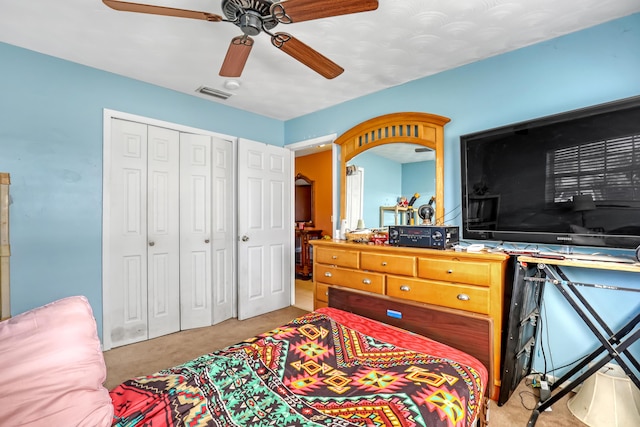 carpeted bedroom featuring a closet and ceiling fan