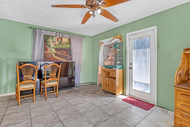 interior space with light tile patterned flooring and ceiling fan