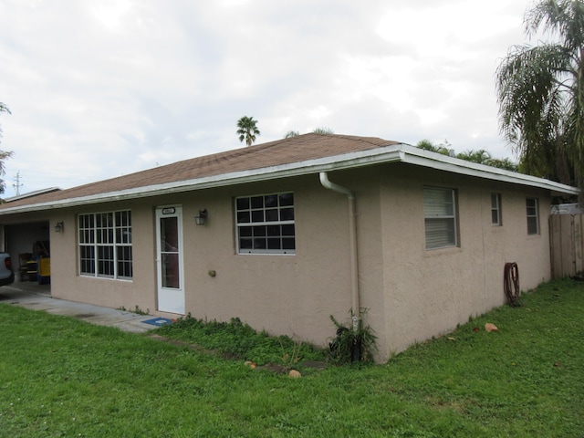 back of property featuring a lawn