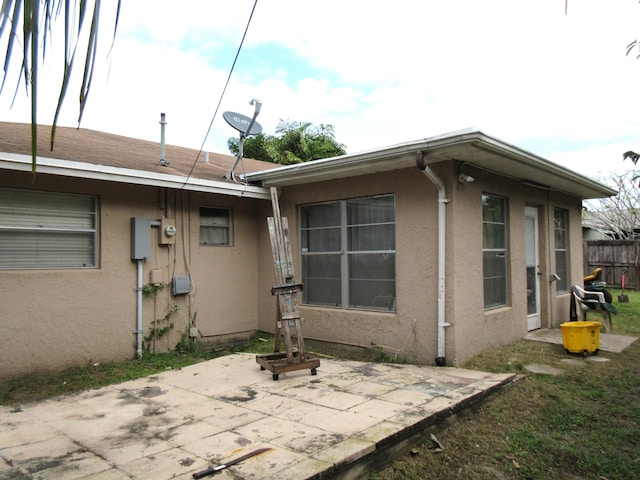 view of side of property with a patio area