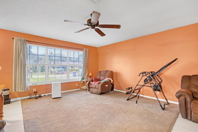 living area featuring tile patterned flooring and ceiling fan