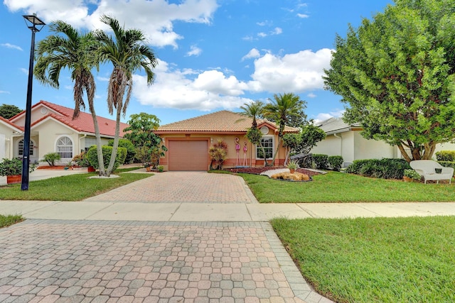 view of front of property featuring a garage and a front yard