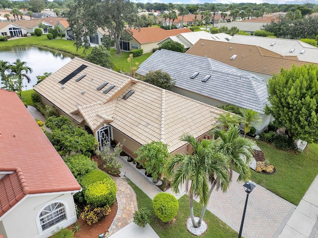 birds eye view of property featuring a water view and a residential view