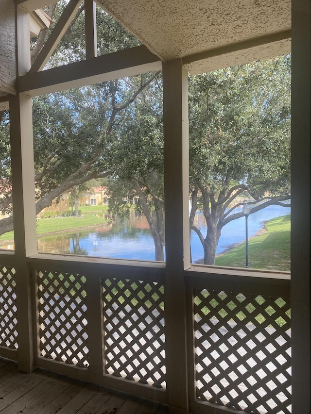 unfurnished sunroom with a water view and a healthy amount of sunlight