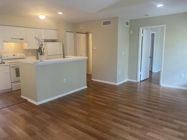 kitchen featuring a center island, white cabinetry, dark hardwood / wood-style flooring, and white appliances