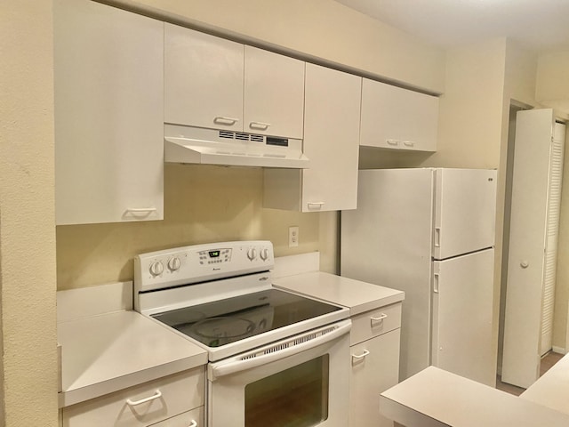 kitchen with white cabinets and white appliances