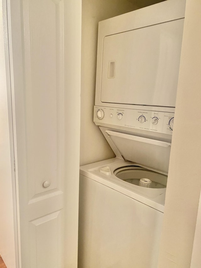 laundry area featuring stacked washing maching and dryer