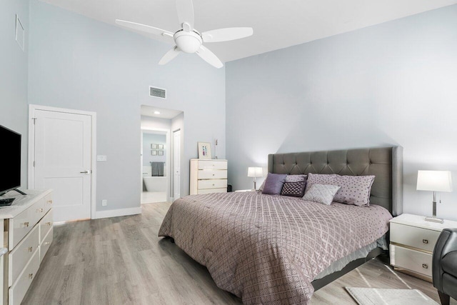 bedroom with ceiling fan, high vaulted ceiling, and light hardwood / wood-style flooring