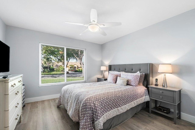 bedroom with light hardwood / wood-style flooring and ceiling fan