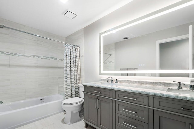 full bathroom with tile patterned flooring, shower / bath combo with shower curtain, vanity, and toilet