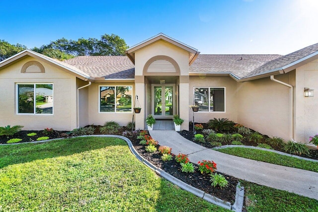 entrance to property with a lawn