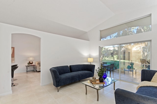 living room featuring tile patterned flooring and lofted ceiling