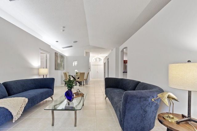 tiled living room featuring lofted ceiling