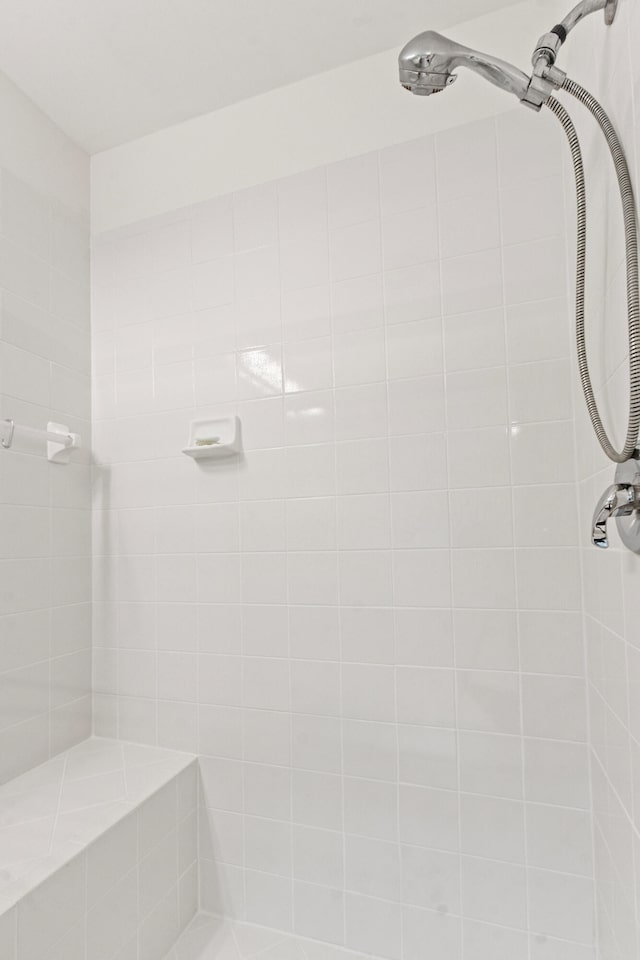 bathroom with tiled shower