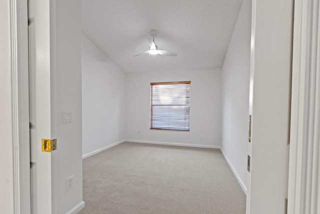 carpeted empty room with a textured ceiling and ceiling fan