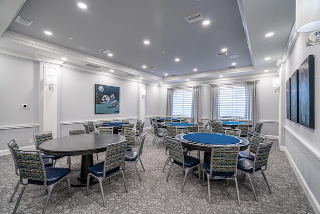 rec room with carpet, a tray ceiling, and ornamental molding