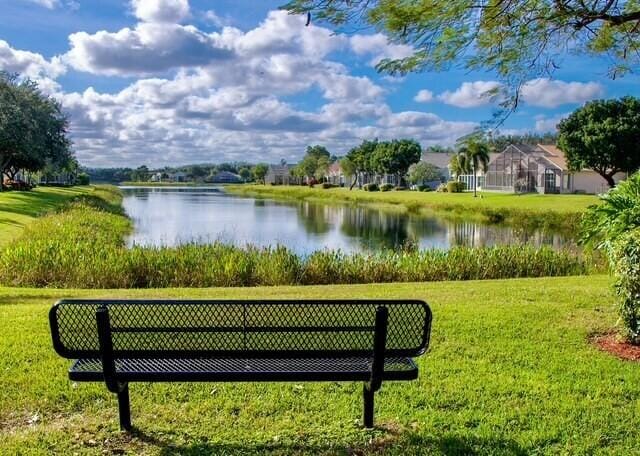 view of property's community with a water view and a yard