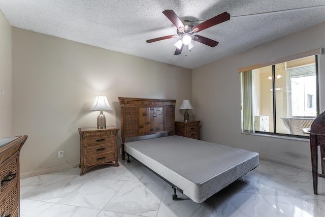 bedroom featuring a textured ceiling and ceiling fan