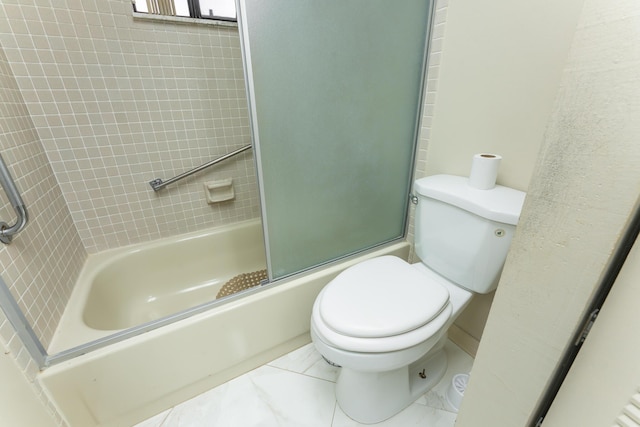 bathroom featuring shower / bath combination with glass door and toilet